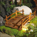 This Wooden Arch Footbridge is a charming addition to any garden